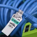 Arista vs Juniper data center switches cost - A bundle of blue CAT6 Ethernet cable plugged into a Raspberry Pi 4 housed in a bright green box.