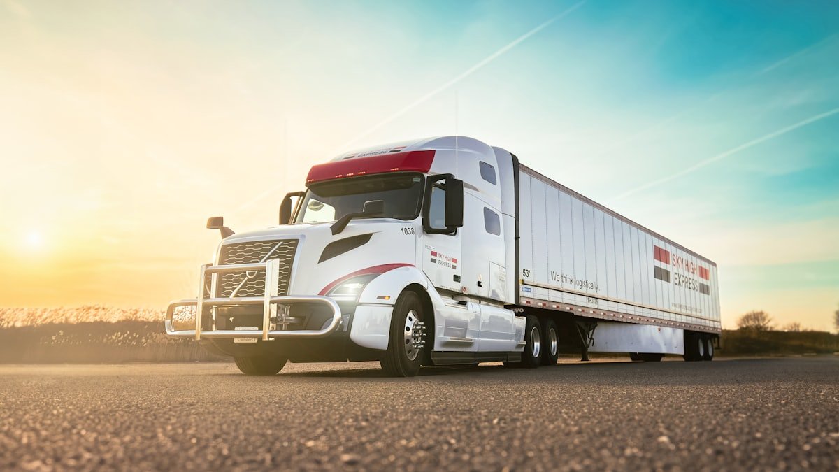 Happy truck driver signing paperwork with factoring company representative