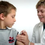 pediatrician near me accepting new patients - The nurse depicted in this 2006 photograph was in the process of administering an intramuscular vaccination in the left shoulder of a young boy. The nurse was pinching the overlying shoulder skin, in order to immobilize the injection site.