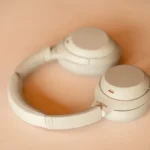 best budget-friendly wireless noise-cancelling headphones USA - Minimalist Sony beige headphones up close on an office desk.